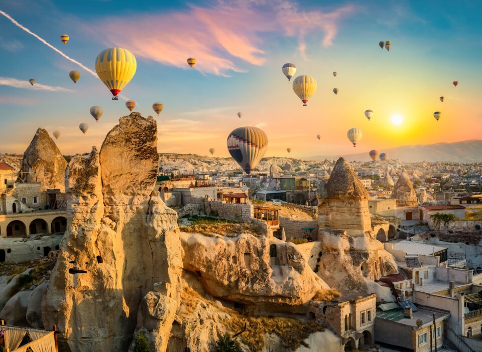 Hot,air,balloons,at,sunset,in,goreme,village,,cappadocia,,turkey